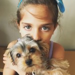 child model with gorgeous eyes holding puppy