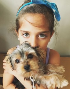 child model with gorgeous eyes holding puppy